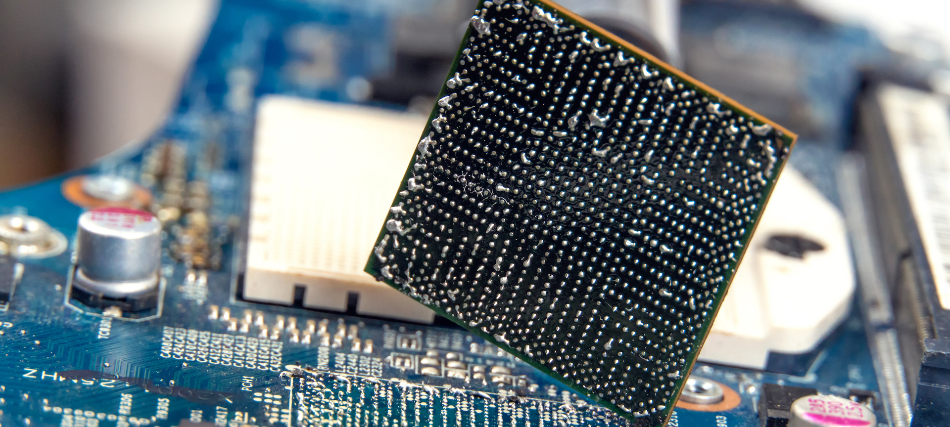 BGA technology balancing on one corner on top of an electronic board